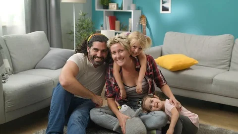 Dad turns on timer on camera for family photo at home Stock Footage 113449819