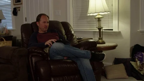 Dad watching tv using remote Stock-Footage 69882334