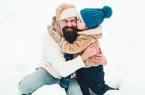 Daddy and boy smiling and hugging. Enjoying nature wintertime. Cute little child Stock Photos