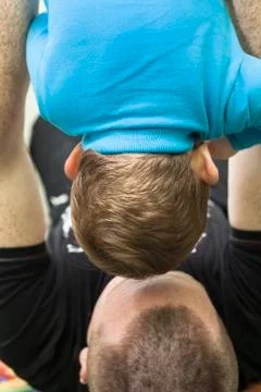 Daddy holding son upside down Stock Photos