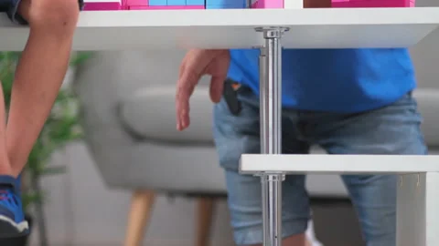 Daddy playing with his son in construction helmets helping and telling him how Stock Footage 131866205