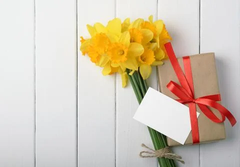 Daffodils with a gift box Stock Photos