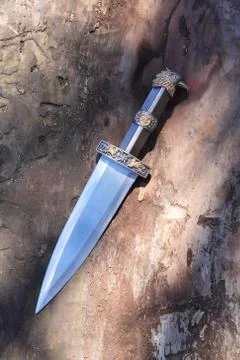 Dagger on wood Stock Photos