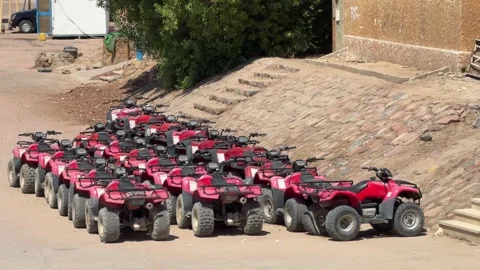 Dahab, Egypt - August 31, 2025: Wide shot of parked atv quad bikes prepared for Video stock 341451973