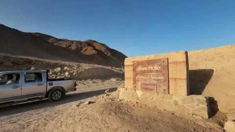 Dahab, Egypt - October 07, 2025: Pickup taxi truck passing Blue Hole sign on 스톡 동영상 340942328