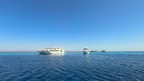 Dahab, Egypt - September 22, 2025: Tourist yachts anchored at coral reef in Red Stock Footage 341838240