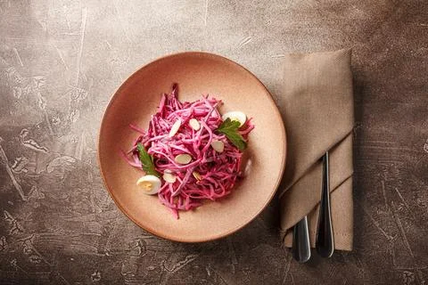 Daikon and beet salad dressed with mayonnaise or yogurt, garnished with almon Stock Photos
