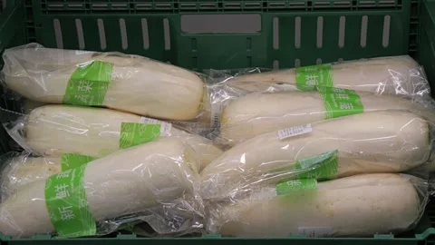 Daikon, White radish, mooli, root vegetable for sale at a supermarket Видео 275835803