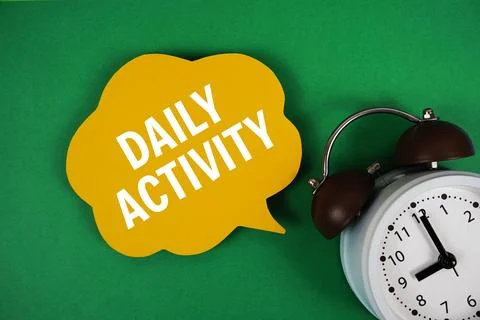 Daily Activity text on speech bubble with alarm clock on green background Stock Photos