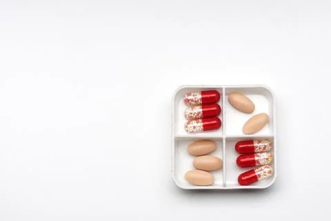 Daily boxes with different tablets and capsules, top view Stock Photos