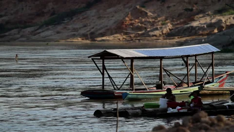 Daily life in amazon river - doing the dishes - kids playing in the water Stock Footage 200845541