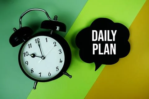 Daily Plan text on speech bubble with alarm clock top view on green and yel.. Stock Photos
