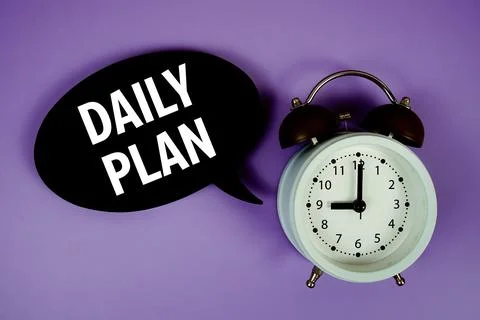 Daily Plan text on speech bubble with alarm clock on purple background Stock Photos