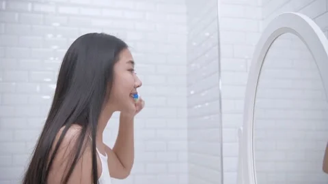 Daily routine concept of 4k Resolution. Asian woman brushing teeth in the bat Stock Footage 144622210