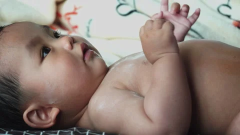 The daily routine of getting dressed is a precious bonding time for motherhood. Stock Footage 302814274