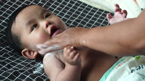 The daily routine of getting dressed is a precious bonding time for motherhood. Stock Footage 302814319