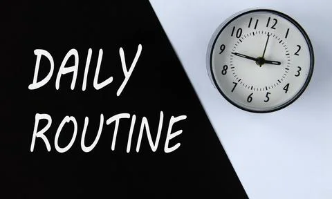 DAILY ROUTINE - words on black background and alarm clock on white Stock Photos