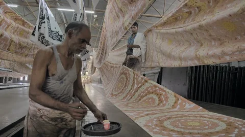 Daily wage workers or laborers printing on cotton sheets Stock Footage 96186473