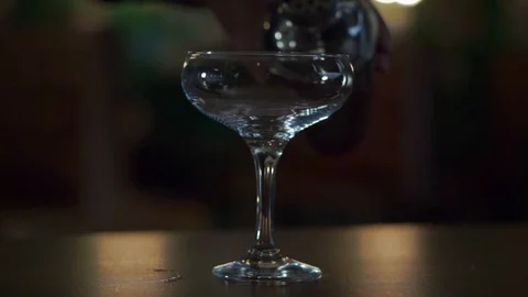 Daiquiri is poured from a shaker into a champagne saucer Stock Footage