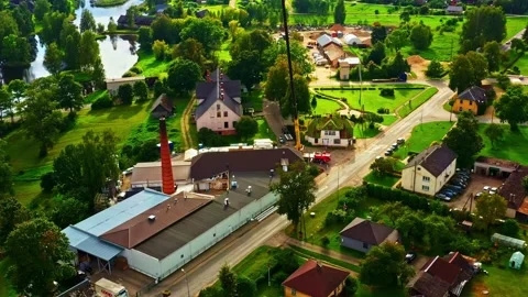 Dairy processing plant operations with crane for reconstruction in a small town Stock Footage 334745252