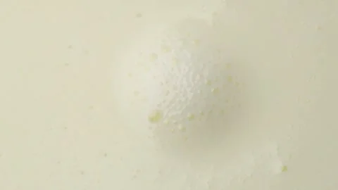 Dairy product with bubbles background, top view, flat lay backdrop. Boiled milk Stock Footage 336065203