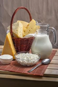 Dairy products on a wooden table, on a light brown background Stock Photos