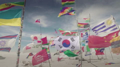 Dakar World Flags, as the Andes and Bolivian Flagss at Uyuni Salar, Bolivia. Stock Footage 136329901