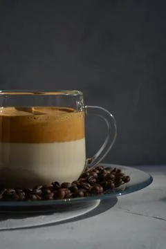 Dalgon coffee on a plate with coffee beans. It's a hard light. Stock Photos