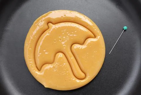 Dalgona candy or Ppopgi. Sugar Honeycomb cookie with umbrella shape with needle  Stock Photos