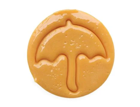 Dalgona candy or Ppopgi. Sugar Honeycomb cookie with umbrella shape  Stock Photos