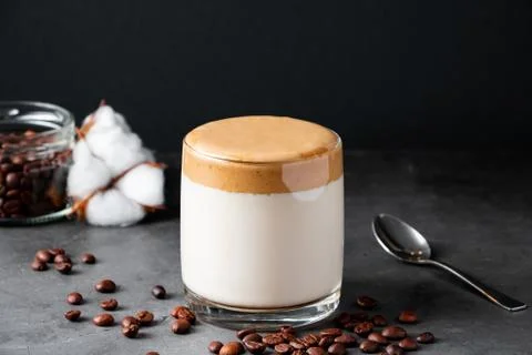 Dalgona coffee on a black background. Making a trendy drink. Fluffy sweet foa Stock Photos