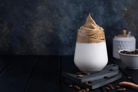 Dalgona coffee on a dark background with copy space. Foto stock