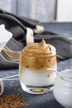 Dalgona coffee in glass on gray background, cooking process, Korean whipped d Stock Photos