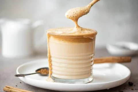Dalgona coffee mixed with a spoon Stock Photos
