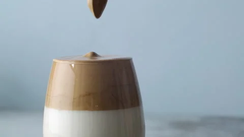 Dalgona coffee, whipped cold coffee with milk. Slow motion. Korean Kitchen Stock Footage 131822471