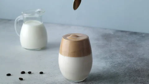 Dalgona coffee, whipped cold coffee with milk. Slow motion. Korean Kitchen Stock Footage 131822478