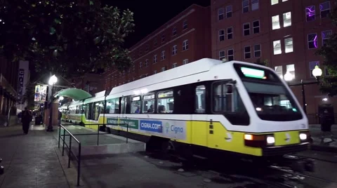Dallas commuter Dart Train leaving downtown station at night Stock Footage