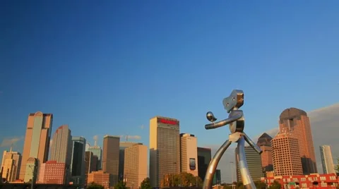 Dallas Skyline Tilt down to commuter train station w/ sculpture Stock Footage
