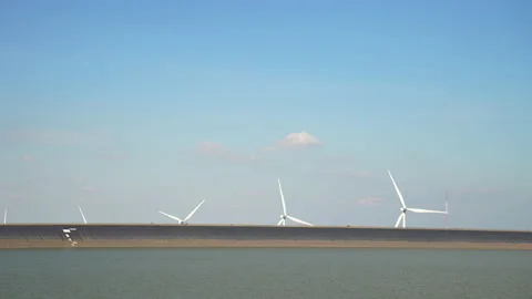 Dam and windmill on blue sky background Stock-Footage 219815408