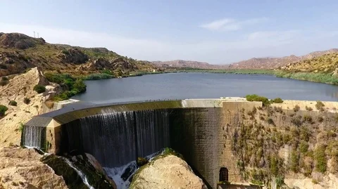 Dam in the city of Elche. First arched dam aerial view. Pantano de Elche lon Stock Footage 128603989