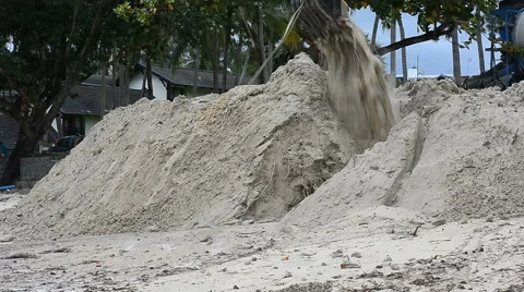 Dam construction with Backhoe along the beach to reduce the waves Stockbeeldmateriaal 64618008