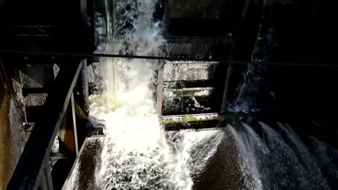 Dam in the countryside. Water pumping structure dividing the river. Strong fl Stock Footage 150454929