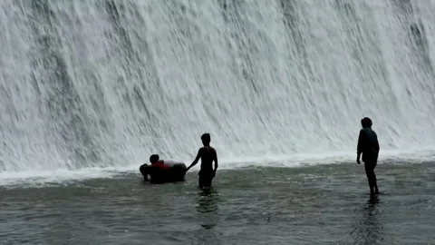 Dam with floodgate, Dam with water overflow, kids playing with water Stock Footage 127344890