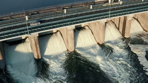 Dam with flowing water through gates. Hydroelectric power station, aerial top Stock Footage 133735689