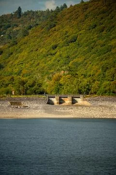 Dam structure below forested hillside in Snowdonia, Wales Stock Photos