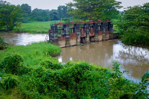 A dam was built in the middle of a small river which is still functioning i.. Stock Photos