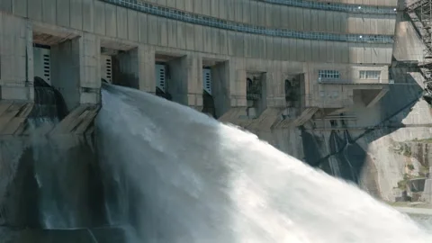 Dam water release. Powerful stream of water flows from power plant reservoir Stock Footage 276574283
