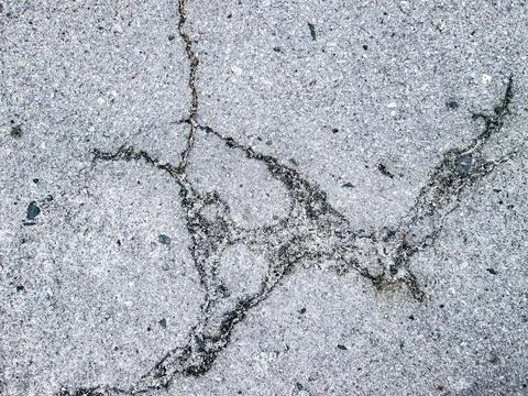 Damage to the asphalt on the road. The texture of the destroyed hard surface. 스톡 사진