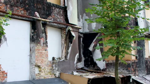 Damage to a house a year after the missile attack, Irpin, Ukraine Stock Footage 246856745