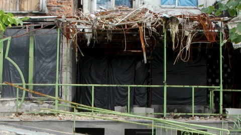 Damage to a house a year after the missile attack, Irpin, Ukraine Stock Footage 246858140
